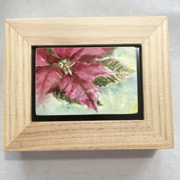 An original watercolor painting of a pink pointsettia in a frame