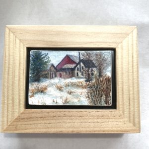 A tiny original watercolor painting of a winter farm with red barn set in a floating frame.