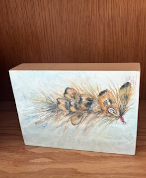 Watercolor painting of a pheasant fly on a wood panel.