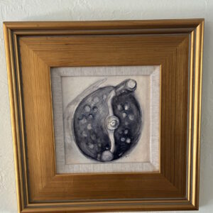 Black Spey reel in an antique gold frame.